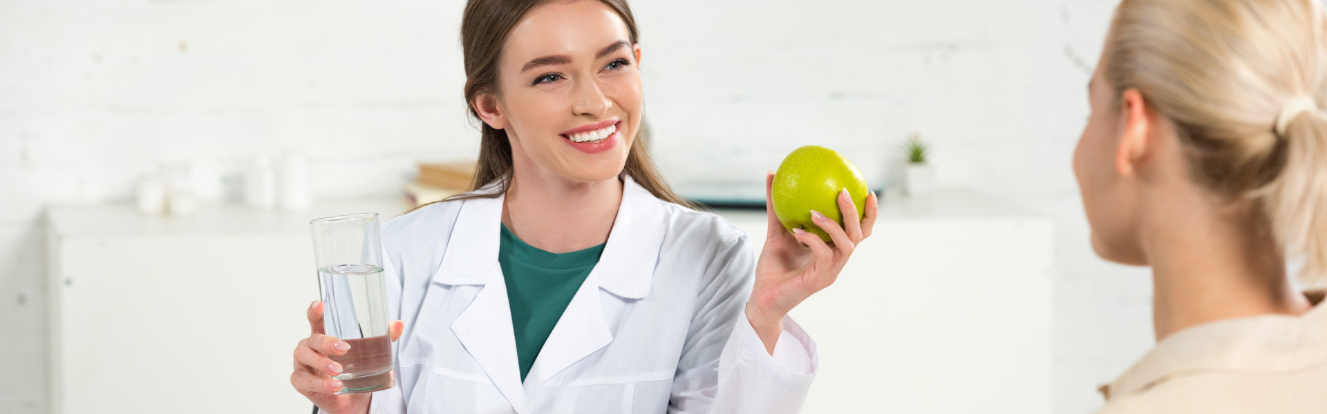 smiling woman in a white lab coat