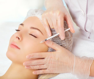  Young woman receiving cosmetic injection on her face